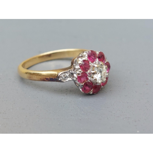 157 - A ruby & diamond cluster ring, small diamonds to shoulders, on '18ct' shank.  Finger size O.