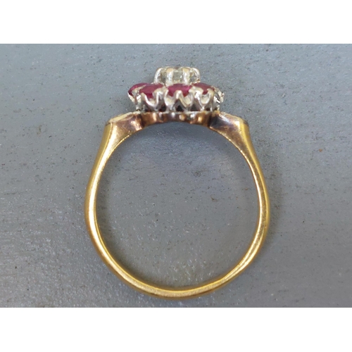 157 - A ruby & diamond cluster ring, small diamonds to shoulders, on '18ct' shank.  Finger size O.