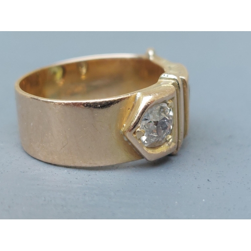 159 - A diamond & green stone set 18ct gold buckle band ring - London marks 1951.  Finger size N/O.