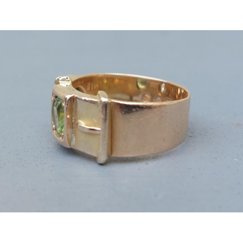 159 - A diamond & green stone set 18ct gold buckle band ring - London marks 1951.  Finger size N/O.