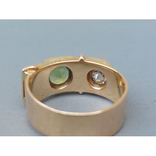 159 - A diamond & green stone set 18ct gold buckle band ring - London marks 1951.  Finger size N/O.