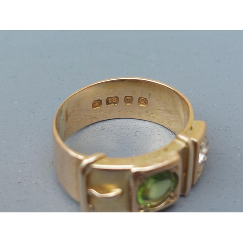 159 - A diamond & green stone set 18ct gold buckle band ring - London marks 1951.  Finger size N/O.