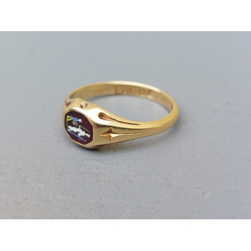 163 - A late Georgian 18ct gold signet style ring, set with a small octagonal red stone decorated with ena... 