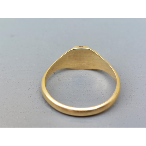 163 - A late Georgian 18ct gold signet style ring, set with a small octagonal red stone decorated with ena... 