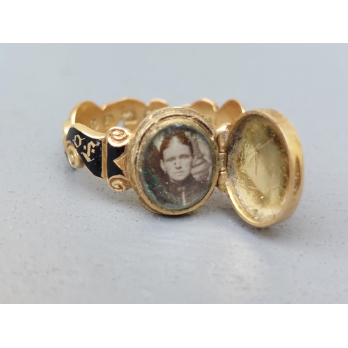 164 - A Victorian black enamelled memoriam ring, a the front with hinged cover set rose cut diamonds, encl... 