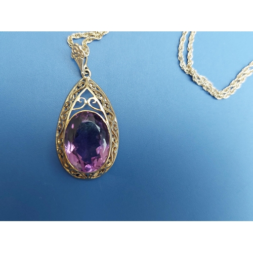 173 - A large amethyst set 9ct gold pear-shaped pendant necklace.