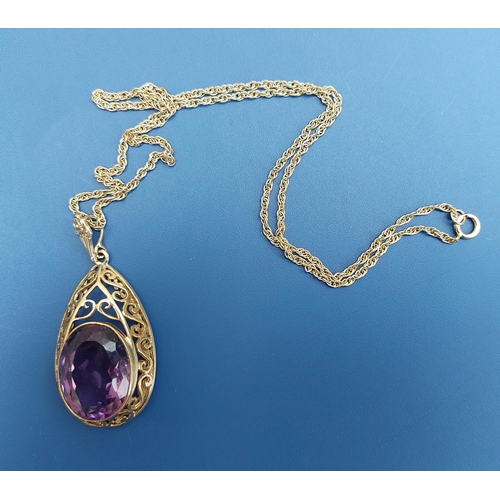 173 - A large amethyst set 9ct gold pear-shaped pendant necklace.