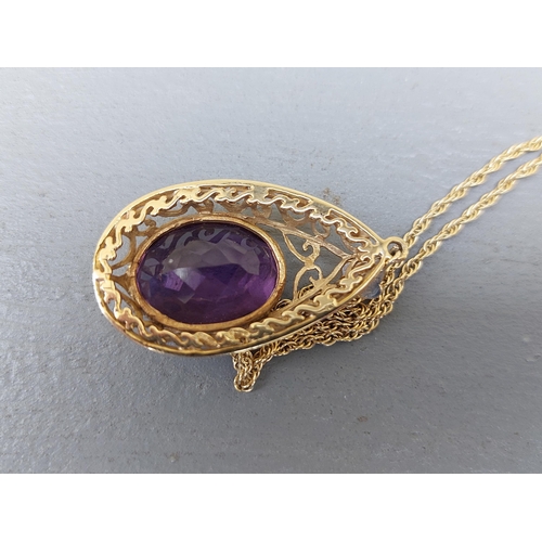 173 - A large amethyst set 9ct gold pear-shaped pendant necklace.