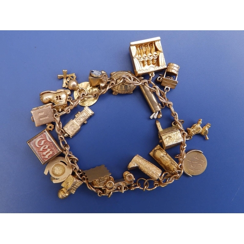 198 - A 9ct gold charm bracelet including can-can girls and Sphinx.