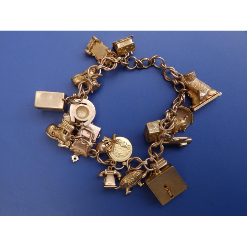 198 - A 9ct gold charm bracelet including can-can girls and Sphinx.