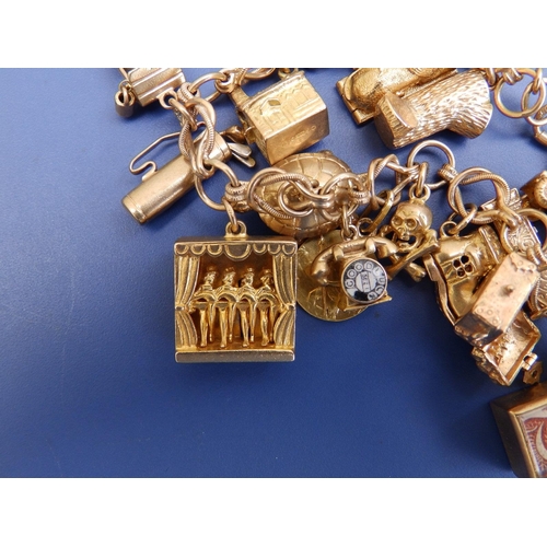 198 - A 9ct gold charm bracelet including can-can girls and Sphinx.