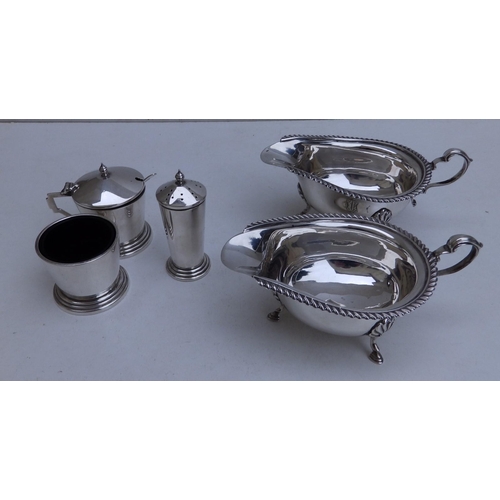 106 - A pair of Birmingham silver sauceboats and a three piece silver condiment set. (5)