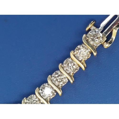 167 - A diamond line bracelet in 10k yellow metal, total diamond weight approximately 4 carats, 7.2