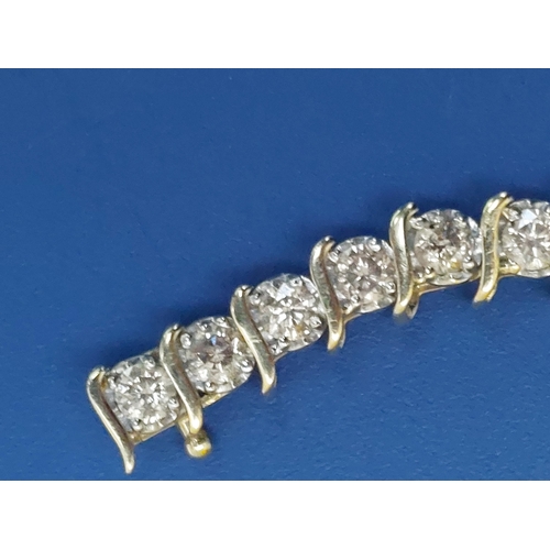 167 - A diamond line bracelet in 10k yellow metal, total diamond weight approximately 4 carats, 7.2