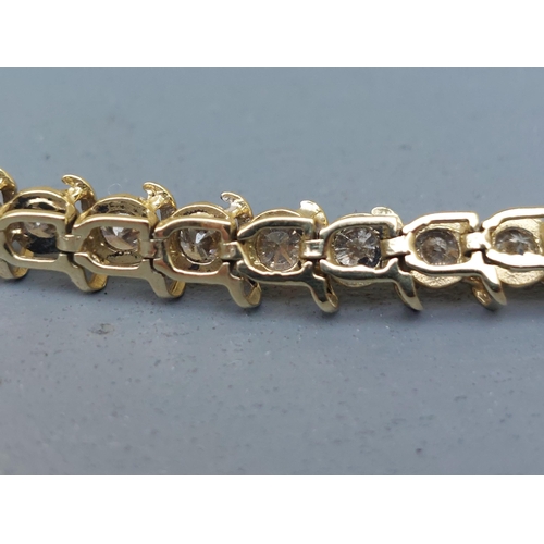 167 - A diamond line bracelet in 10k yellow metal, total diamond weight approximately 4 carats, 7.2