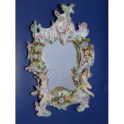 28 - A small Meissen rococo style wall mirror modelled with figures.