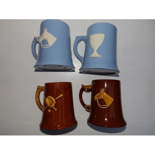 29 - Four plain coloured Dartmouth pottery mugs decorated equestrian/sporting subjects.