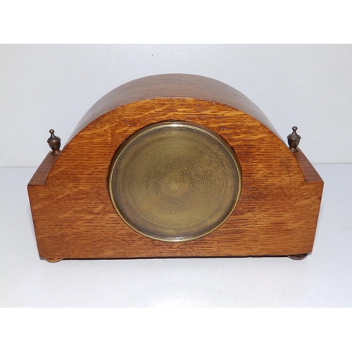 63 - A low Edwardian veneered oak mantel clock.