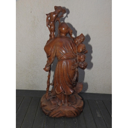 79 - A Chinese detailed carved wood study of an Immortal with crane.