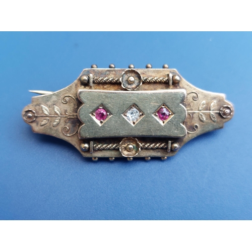 171 - A 19thC memoriam brooch, set with small rubies and a diamond, the glazed compartment to reverse cont... 