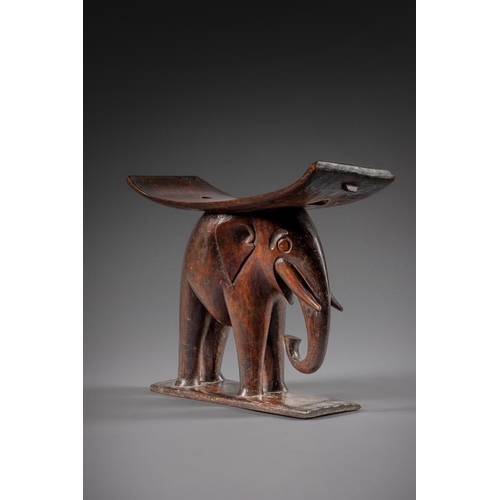 605 - AN UNUSUAL ASHANTI WOOD STOOL LATE 19TH/EARLY 20TH CENTURY With elephant support 50cm high, 55.5cm w... 