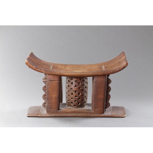 607 - AN OLD EXAMPLE OF AN ASHANTI STOOL GHANA, 19TH CENTURY 32cm high, 54.5cm wide Together with another ... 