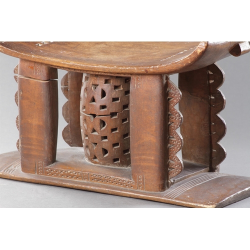 607 - AN OLD EXAMPLE OF AN ASHANTI STOOL GHANA, 19TH CENTURY 32cm high, 54.5cm wide Together with another ... 