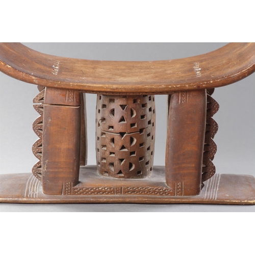 607 - AN OLD EXAMPLE OF AN ASHANTI STOOL GHANA, 19TH CENTURY 32cm high, 54.5cm wide Together with another ... 