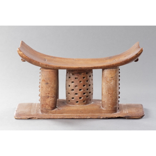 607 - AN OLD EXAMPLE OF AN ASHANTI STOOL GHANA, 19TH CENTURY 32cm high, 54.5cm wide Together with another ... 