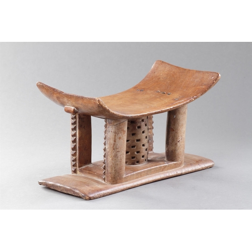 607 - AN OLD EXAMPLE OF AN ASHANTI STOOL GHANA, 19TH CENTURY 32cm high, 54.5cm wide Together with another ... 