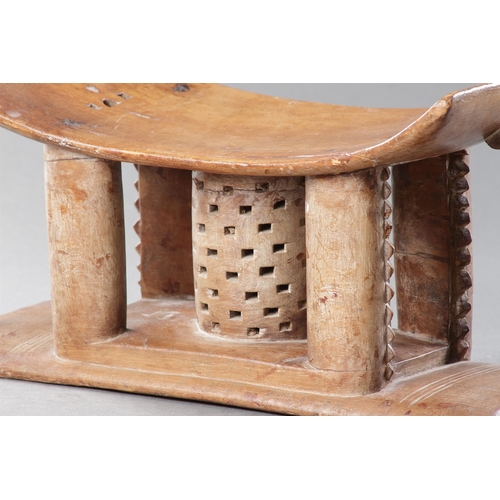 607 - AN OLD EXAMPLE OF AN ASHANTI STOOL GHANA, 19TH CENTURY 32cm high, 54.5cm wide Together with another ... 