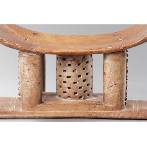 607 - AN OLD EXAMPLE OF AN ASHANTI STOOL GHANA, 19TH CENTURY 32cm high, 54.5cm wide Together with another ... 