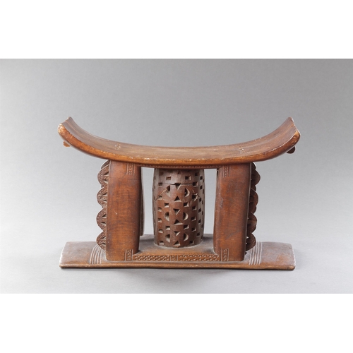 607 - AN OLD EXAMPLE OF AN ASHANTI STOOL GHANA, 19TH CENTURY 32cm high, 54.5cm wide Together with another ... 