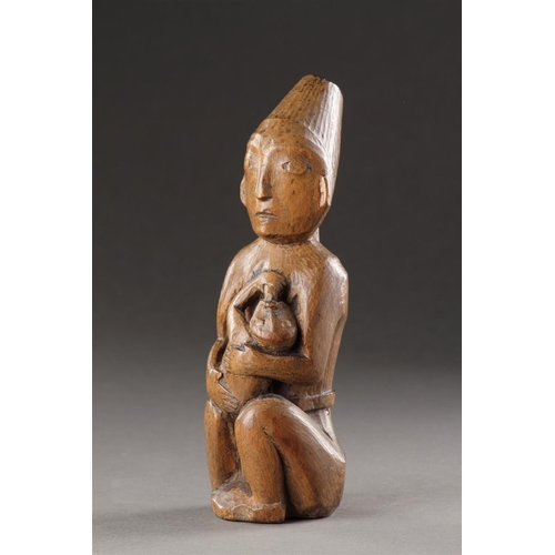 629 - A RARE AND EARLY NORTHWEST COAST CARVED WOOD MATERNITY FIGURE KWAKIUTL (KWAKWAKA 'WAKW'), 19TH CENTU... 