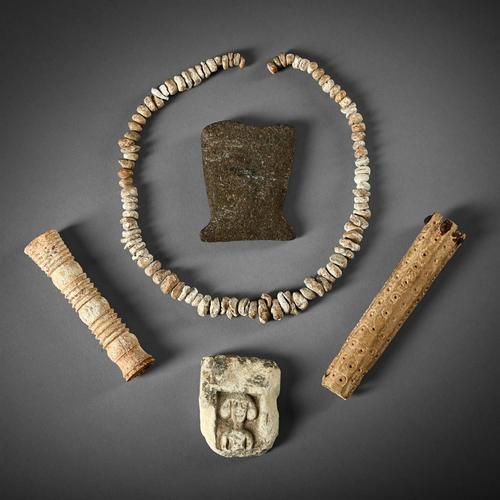 663 - A GROUP OF FIVE ANTIQUITIES TO INCLUDE: A roundel carved pierced section of bone, 15.5cm long A neck... 