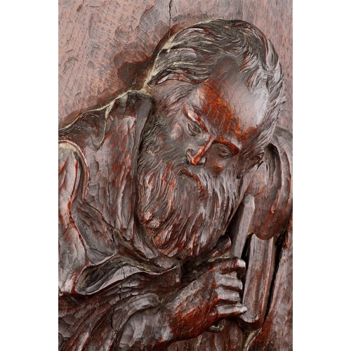 681 - A FINELY CARVED OAK HIGH RELIEF OF ST JOHN 17TH CENTURY Of good colour and patina, depicted holding ... 