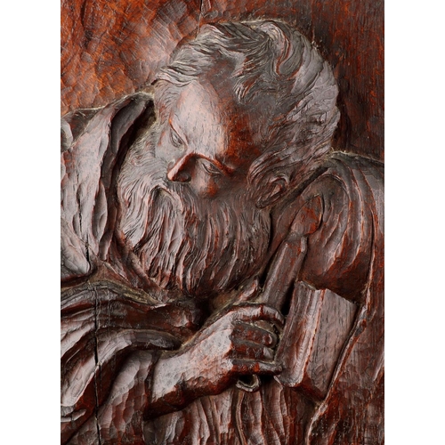 681 - A FINELY CARVED OAK HIGH RELIEF OF ST JOHN 17TH CENTURY Of good colour and patina, depicted holding ... 