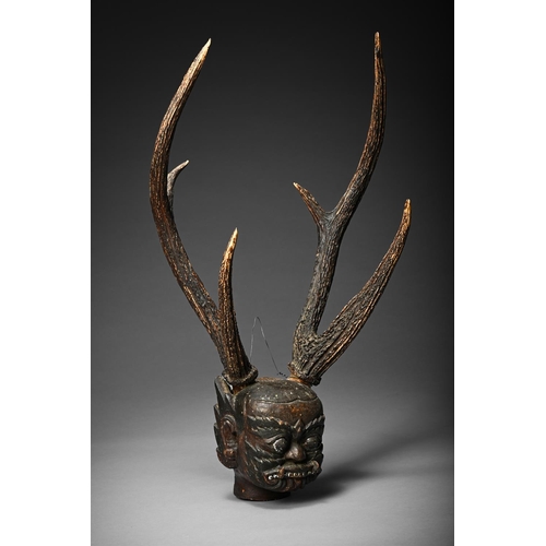 715 - AN ASIAN ONI SKULL POSSIBLY DEPICTING BARONG POSSIBLY INDONESIAN, LATE 19TH CENTURY Carved wood head... 