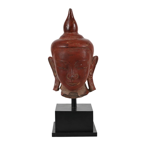 783 - A BURMESE LACQUERED STONE BUDDHA HEAD  18TH OR 19TH CENTURYThe buddha 42cm high, 60cm high including... 