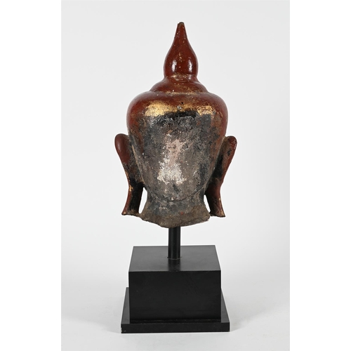 783 - A BURMESE LACQUERED STONE BUDDHA HEAD  18TH OR 19TH CENTURYThe buddha 42cm high, 60cm high including... 