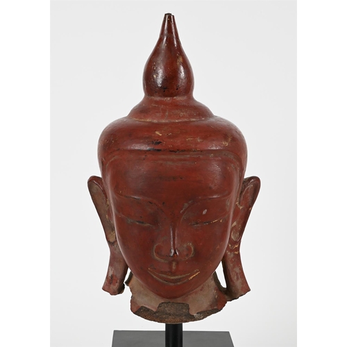 783 - A BURMESE LACQUERED STONE BUDDHA HEAD  18TH OR 19TH CENTURYThe buddha 42cm high, 60cm high including... 