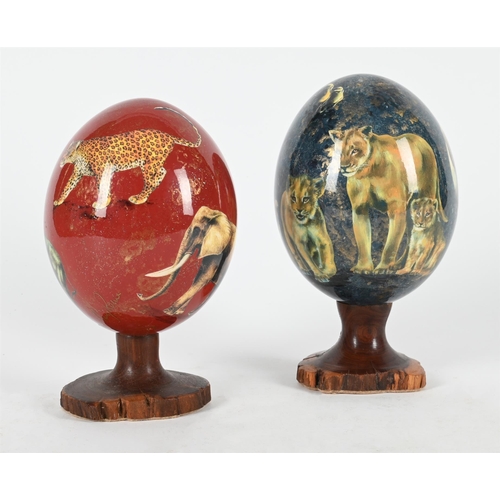 799 - λ SHERRY ROWE (SOUTH AFRICAN, CONTEMPORARY), TWO MODERN DECOUPAGE OSTRICH EGGS Decorated in mega fau... 