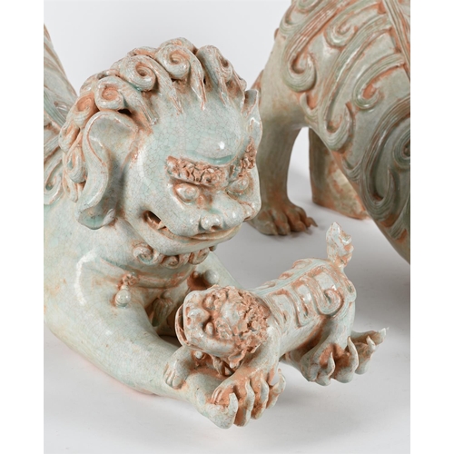 814 - A PAIR OF CHINESE PORCELAIN CELADON GLAZE MODELS OF LIONS AND CUBS20TH CENTURY 58cm long