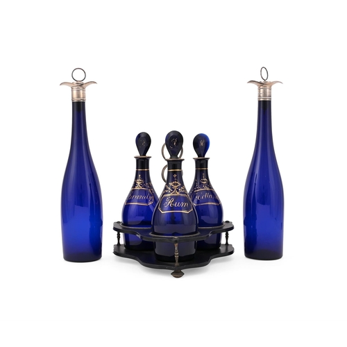 826 - A SET OF THREE BRISTOL BLUE GLASS DECANTERS 19TH CENTURY Gilt inscribed Rum, Holland and Brandy, ini... 