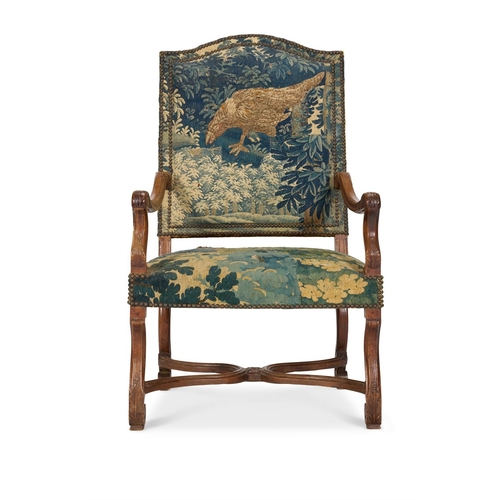 15 - A MATCHED PAIR OF WALNUT AND VERDURE TAPESTRY UPHOLSTERED ARMCHAIRS FRENCH, EARLY 18TH CENTURYOne wi... 