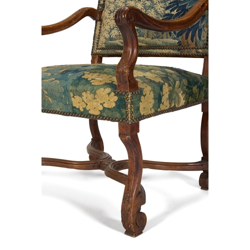 15 - A MATCHED PAIR OF WALNUT AND VERDURE TAPESTRY UPHOLSTERED ARMCHAIRS FRENCH, EARLY 18TH CENTURYOne wi... 