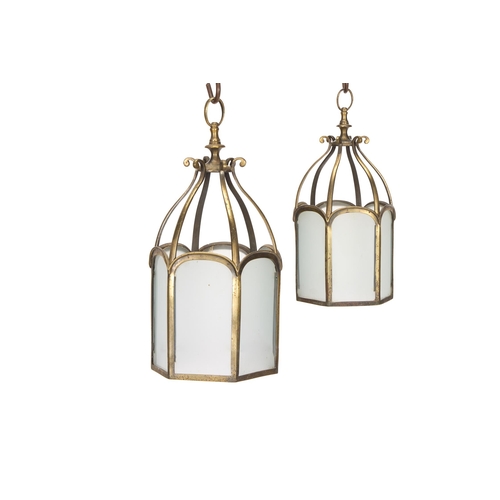 217 - A PAIR OF GILT BRASS HALL OR PORCH PENDANT LANTERNS EARLY 20TH CENTURY Of hexagonal form, arched pan... 