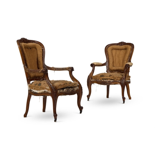 219 - A PAIR OF VICTORIAN CARVED WALNUT ARMCHAIRS CIRCA 1860 In need of reupholstery, each show-frame with... 