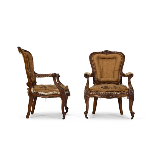 219 - A PAIR OF VICTORIAN CARVED WALNUT ARMCHAIRS CIRCA 1860 In need of reupholstery, each show-frame with... 