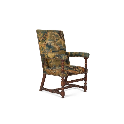 46 - A WALNUT AND VERDURE TAPESTRY UPHOLSTERED ARMCHAIR 18TH CENTURYWith bobbin turned supports throughou... 